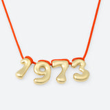 COLLIER AVEC QUATRE NUMÉROS